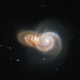 Distant orange and whitish galaxies overlap one another in space.